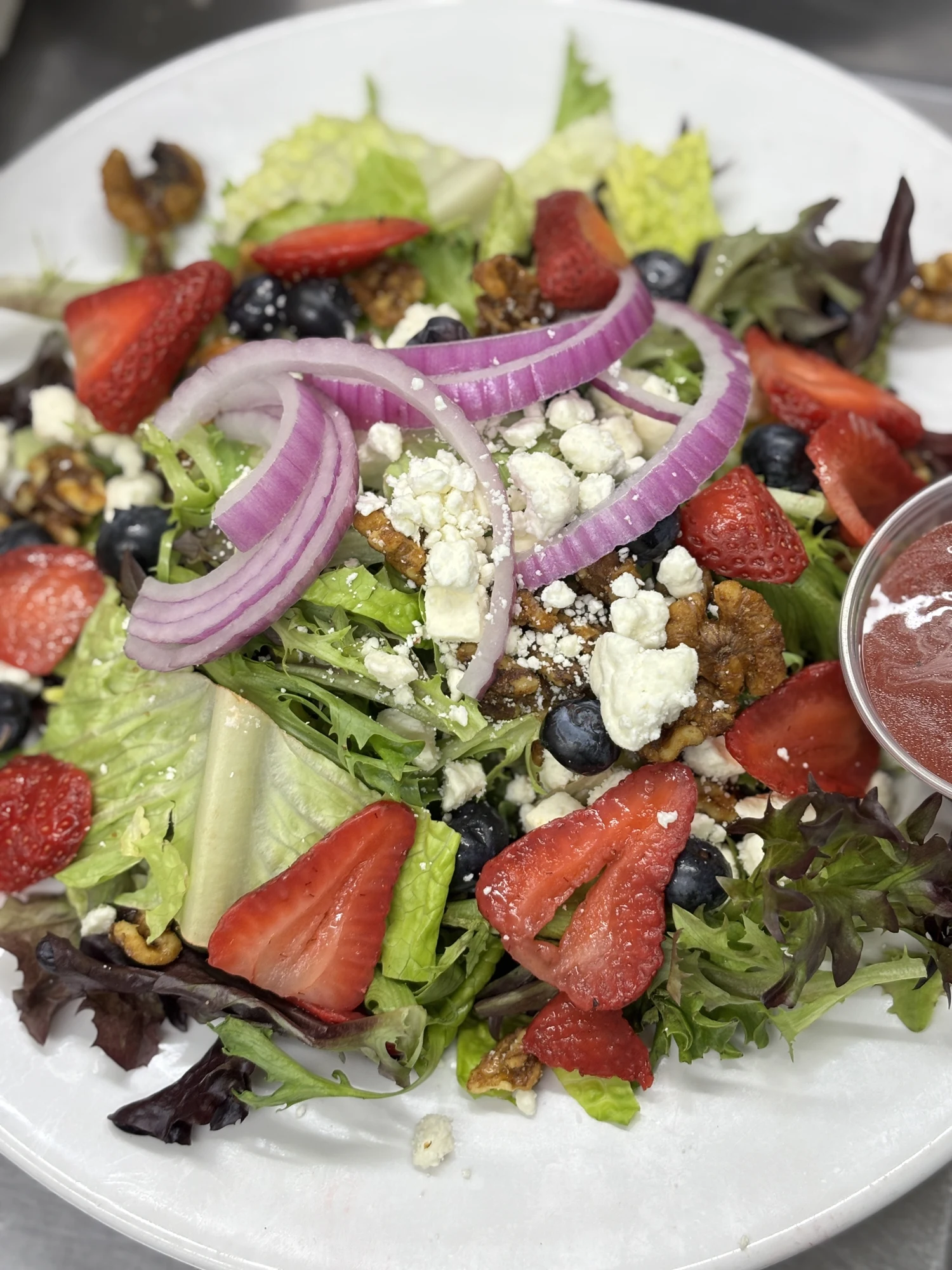 Garden salad with strawberries and blueberries